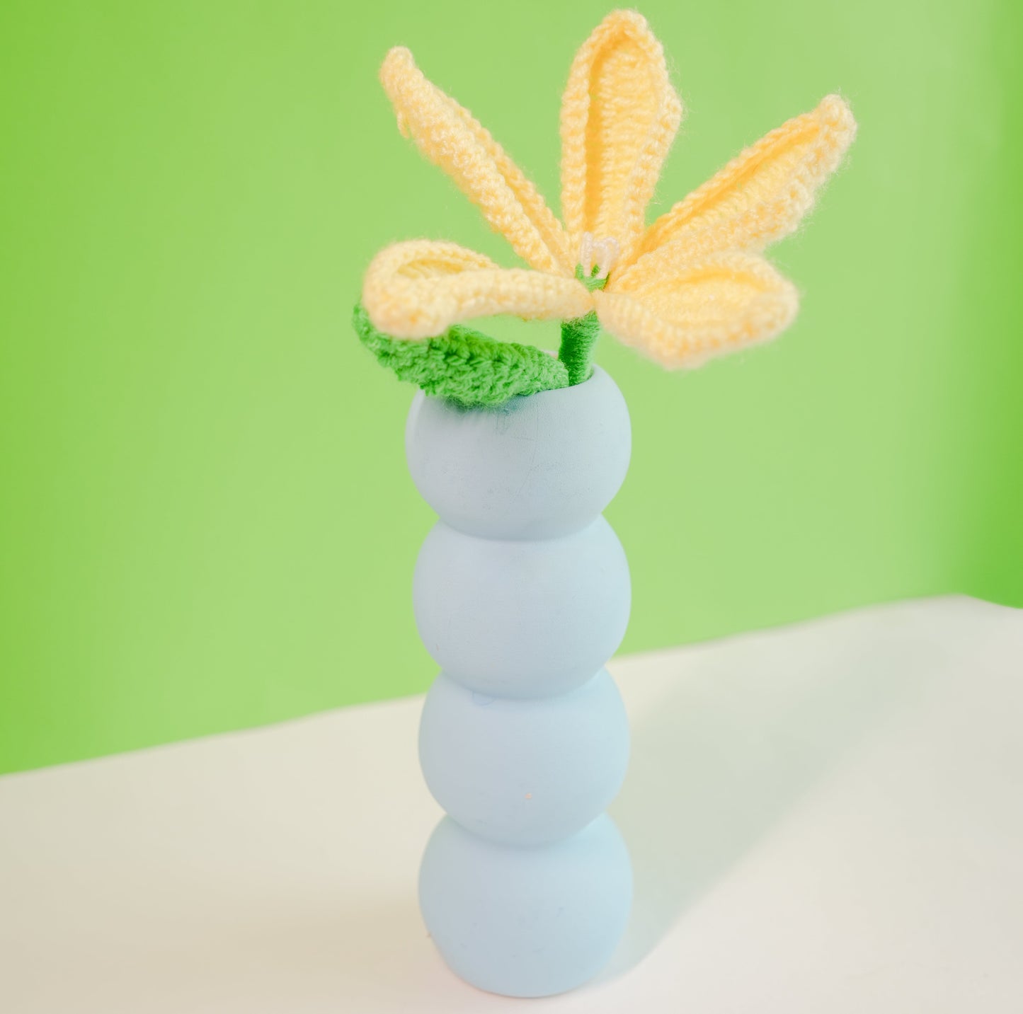 Stacked tiered pottery vase with crochet yellow Lily