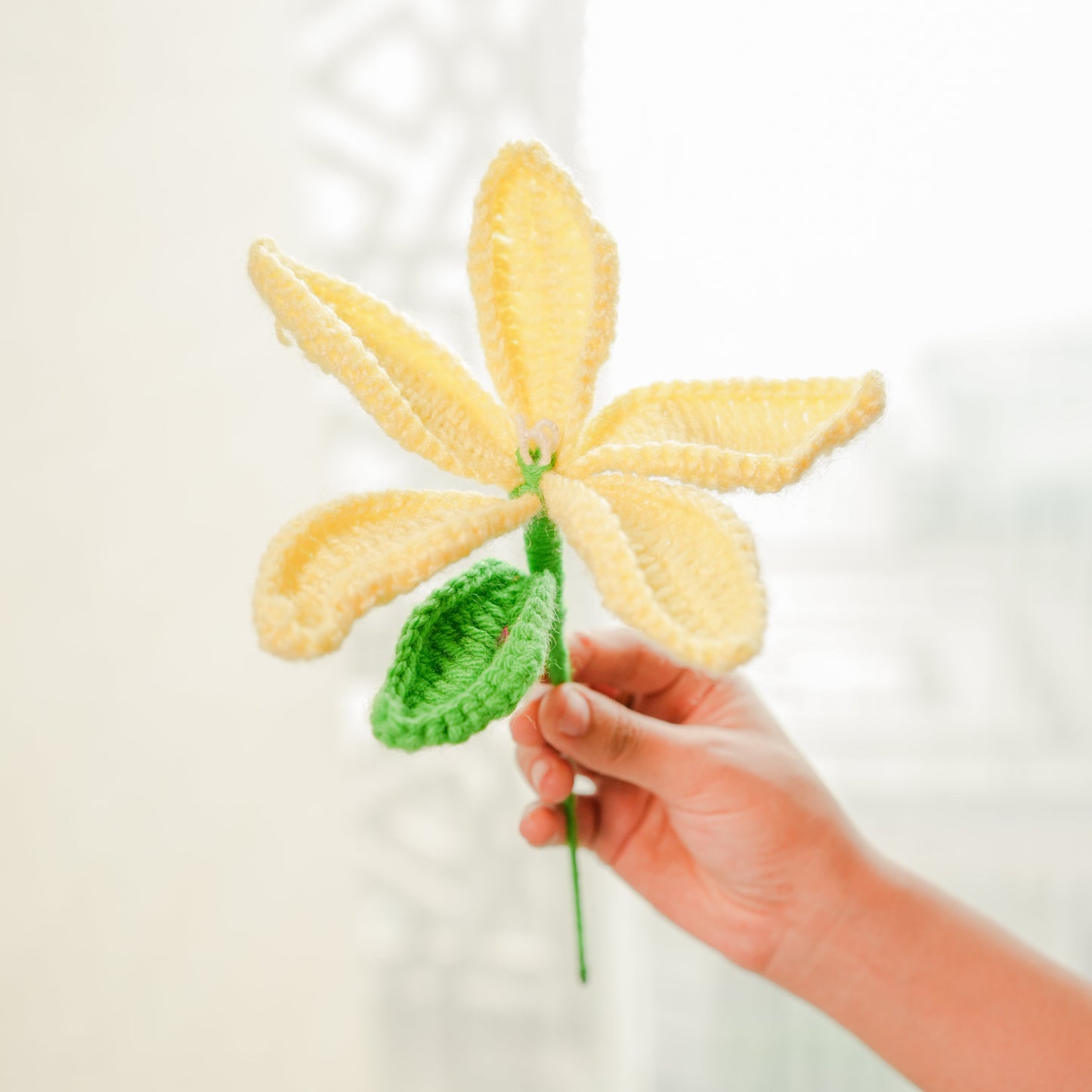 Stacked tiered pottery vase with crochet yellow Lily