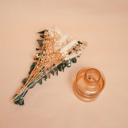little blossom vase with dried flower bunch in mini glass vase